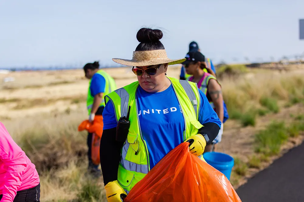 United Airlines volunteer collecting trash in Hawaii
